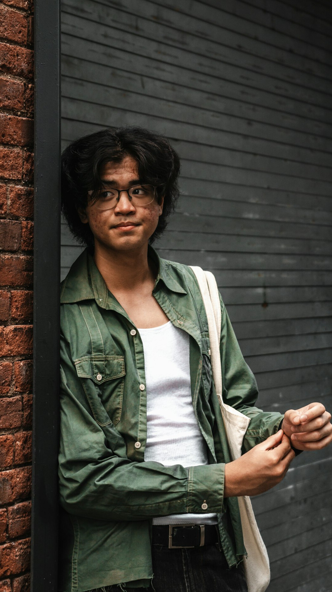 Portrait of a man with glasses and dark hair in a smart casual outfit