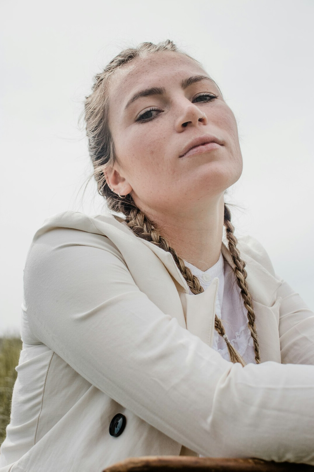 Portrait of a young woman with blond hair in a light blazer