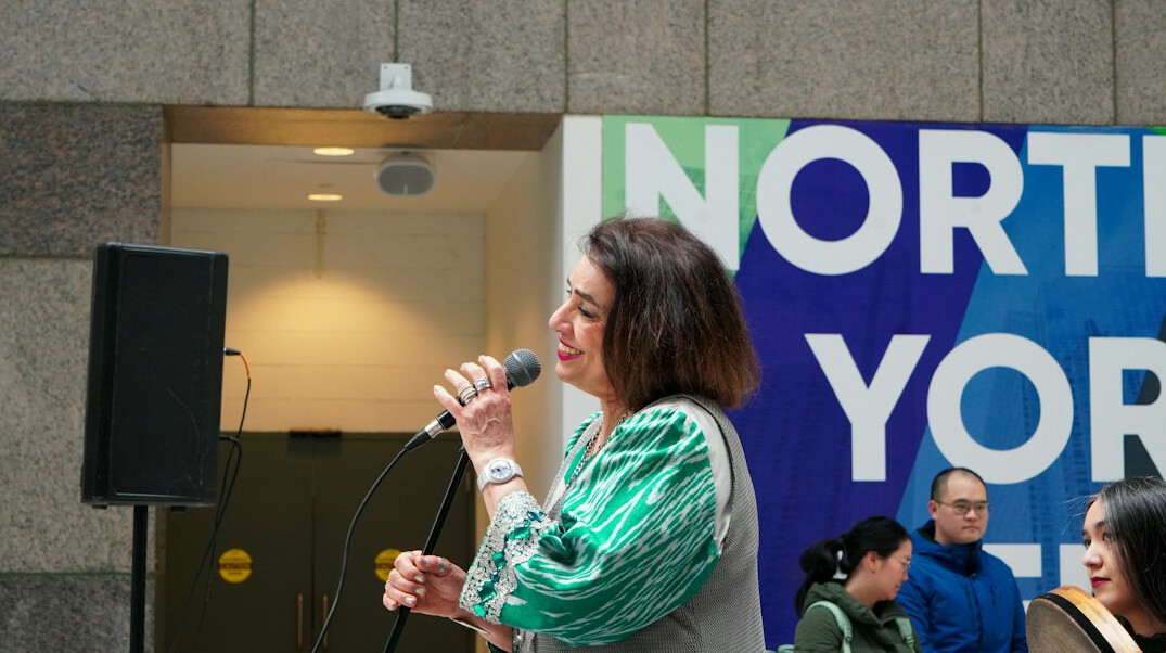 woman giving speech on stage