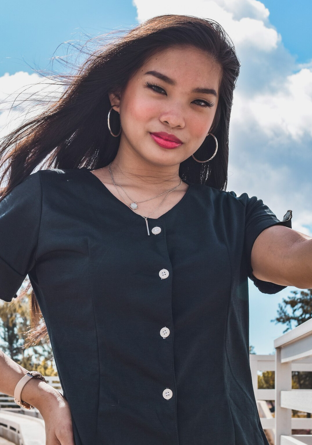 Portrait of a smiling woman with dark hair in a business outfit